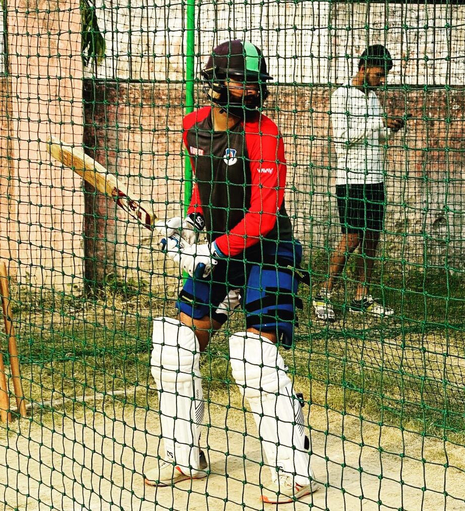 Cricket player practicing inside Sai Cricket Academy nets